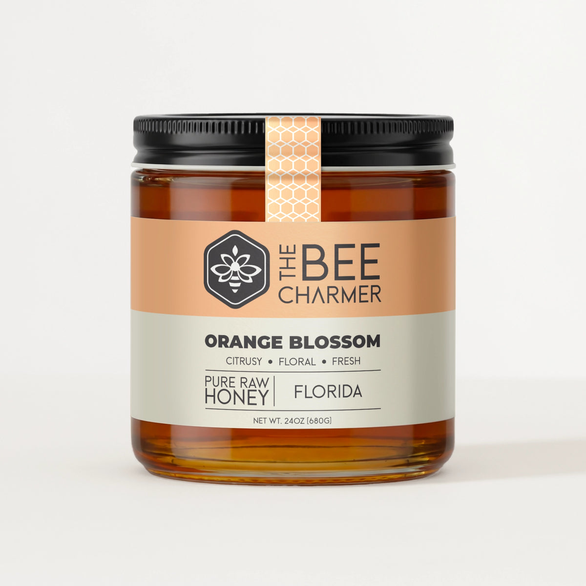 Pure raw Orange Blossom honey in a signature Bee Charmer branded 24oz wide-mouth glass jar.  This is our largest available size.