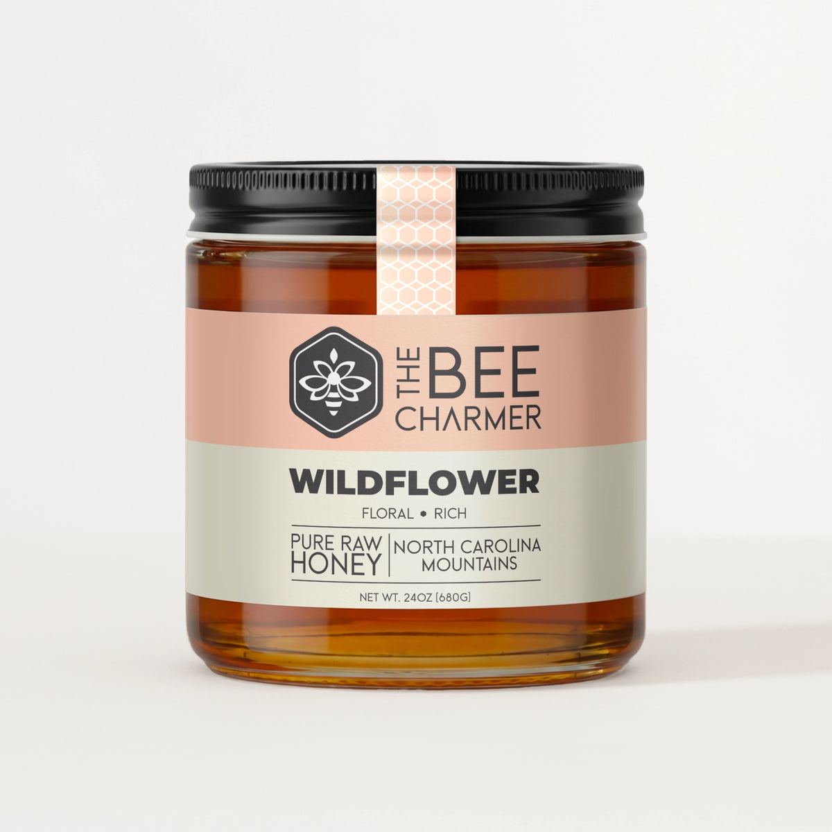 Pure raw Wildflower Honey in a signature Bee Charmer branded 24oz wide-mouth glass jar.  This is our largest available size.