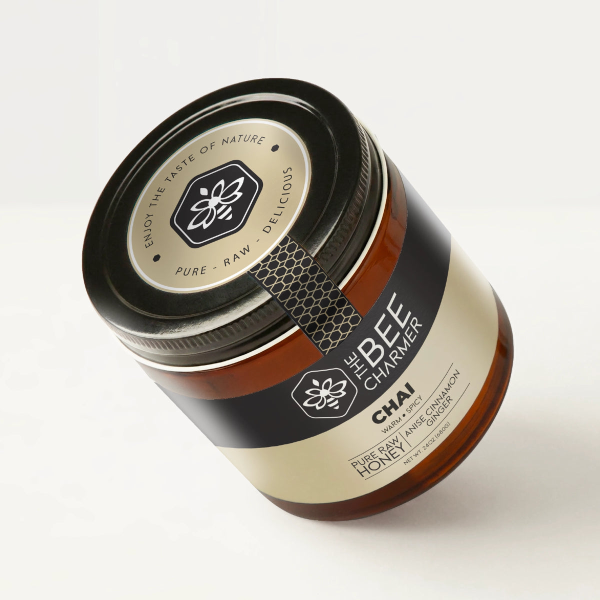 Anise Cinnamon Ginger-infused Chai Honey in a signature Bee Charmer branded 24oz wide-mouth glass jar showing the top of the jar label.