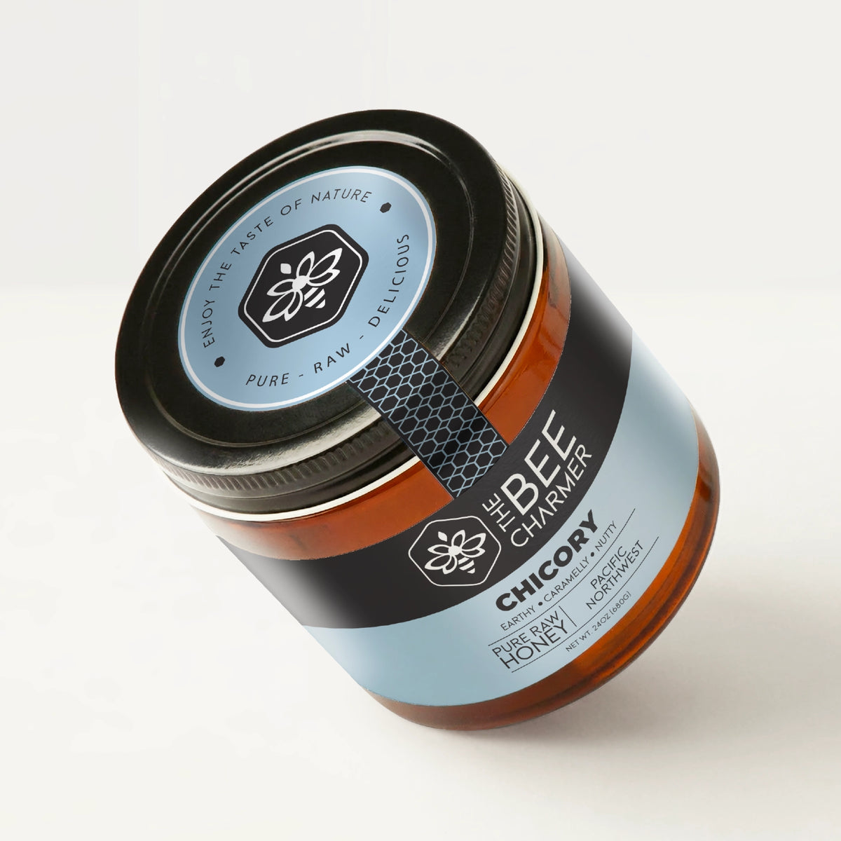 Pure raw Chicory Honey in a signature Bee Charmer branded 24oz wide-mouth glass jar showing the top of the jar label.