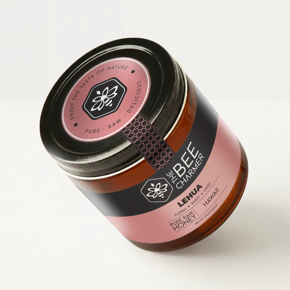 Pure raw Lehua Honey in a signature Bee Charmer branded 24oz wide-mouth glass jar showing the top of the jar label.