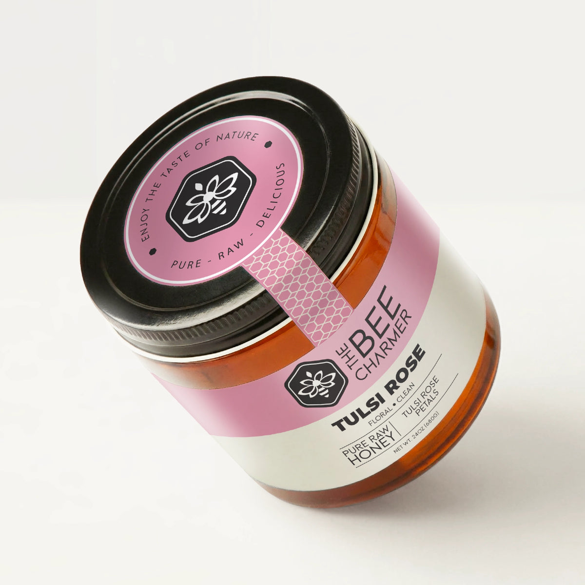 Tulsi Rose Honey in a signature Bee Charmer branded 24oz wide-mouth glass jar showing the top of the jar label.
