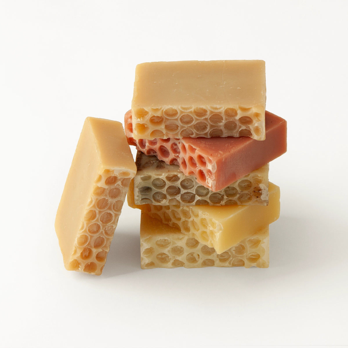 An assortment of natural honey-based soap bars showing the different scents available at The Bee Charmer.