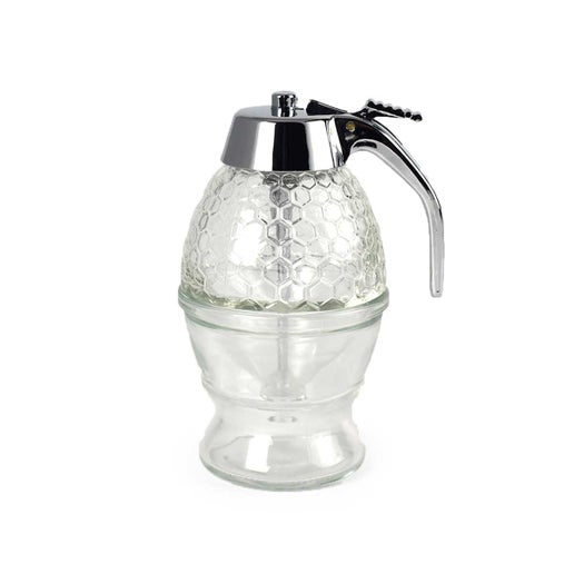 The Bee Charmer's glass honeycombed honey dispenser with a warming bottom and silver handle.