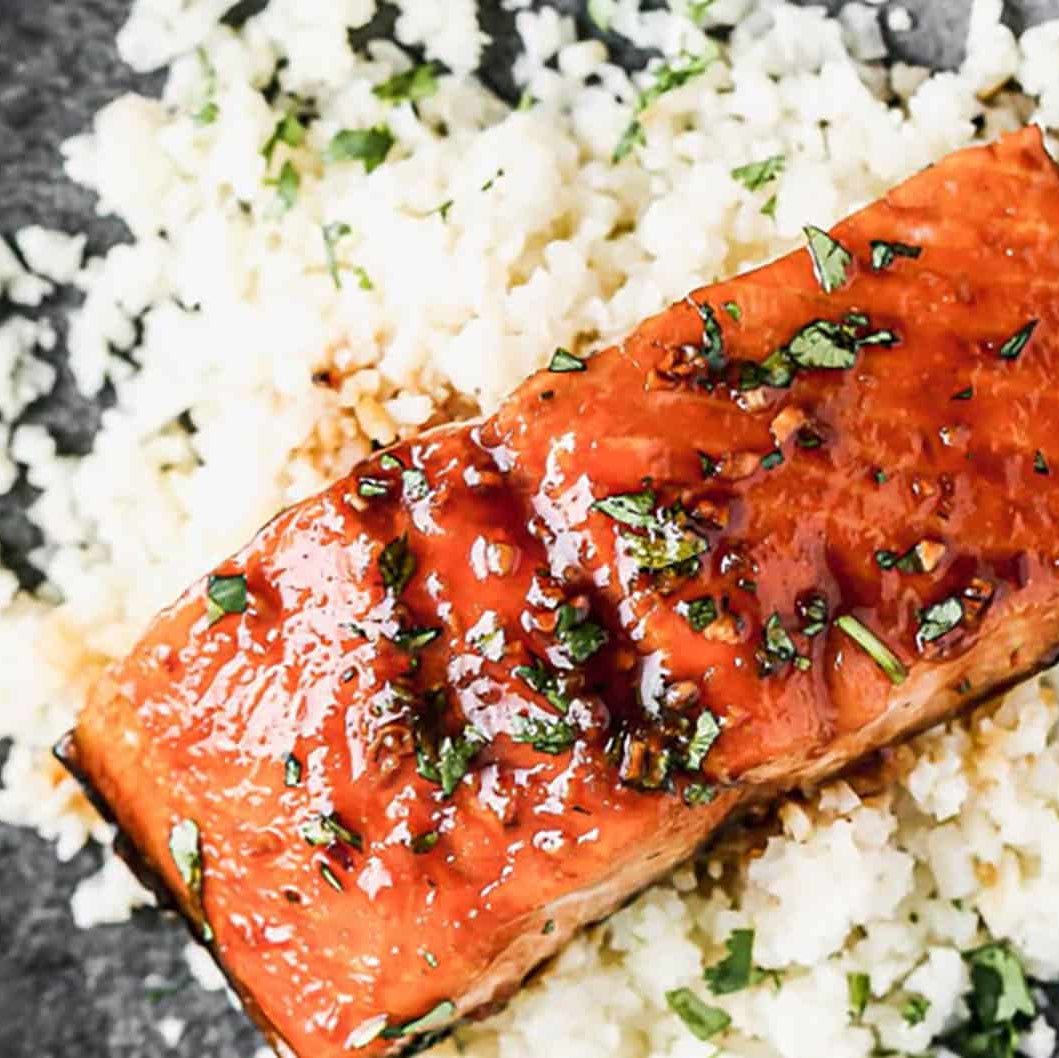 Grilled salmon with honey glaze on a bed of rice with herbs